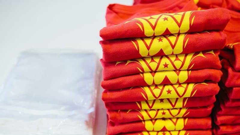 A stack of t-shirts all ready to be shipped directly to the purchaser!