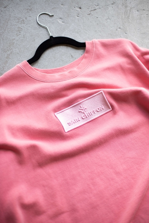 Pink sweatshirt with a lighter pink embroidered design