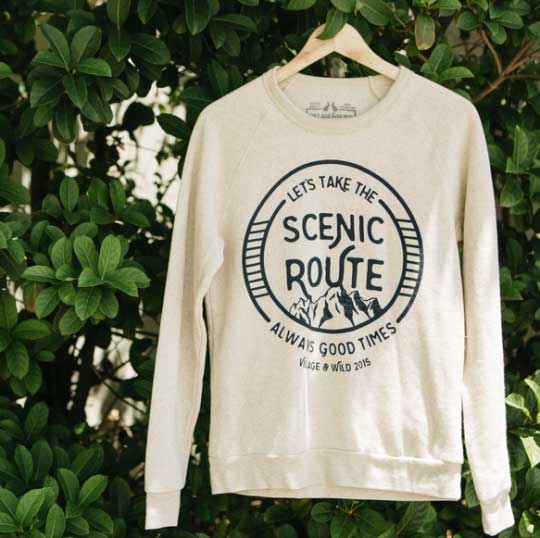 white sweater hanging on a branch outside