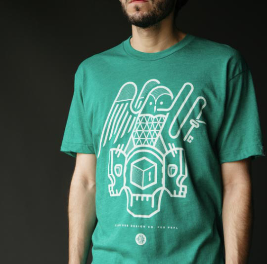 man standing with green shirt with white owl graphic