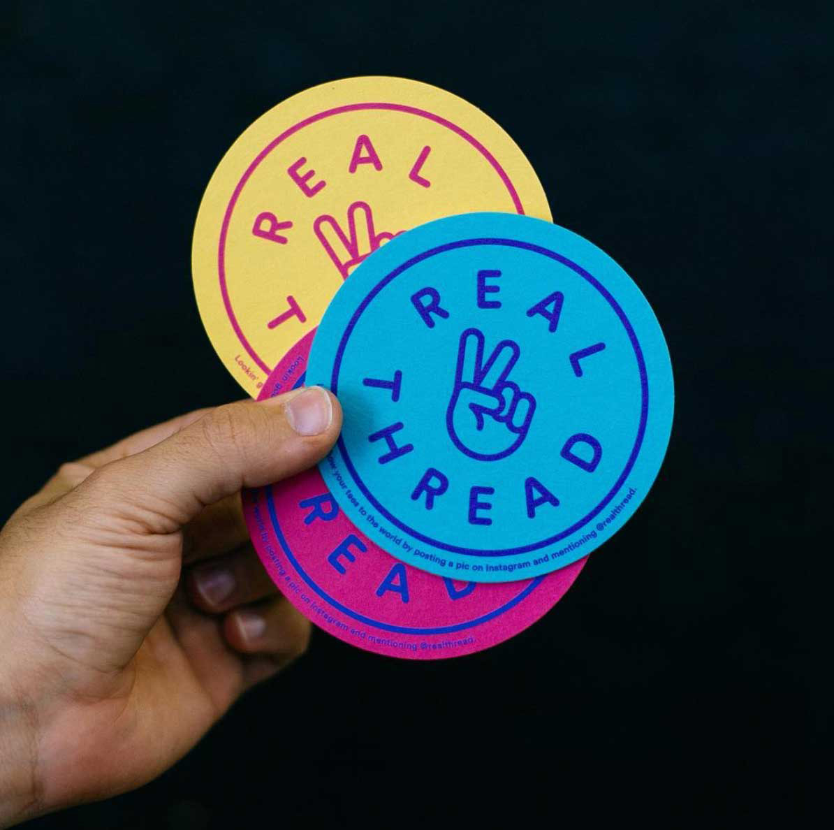 hand holding three real thread coaster