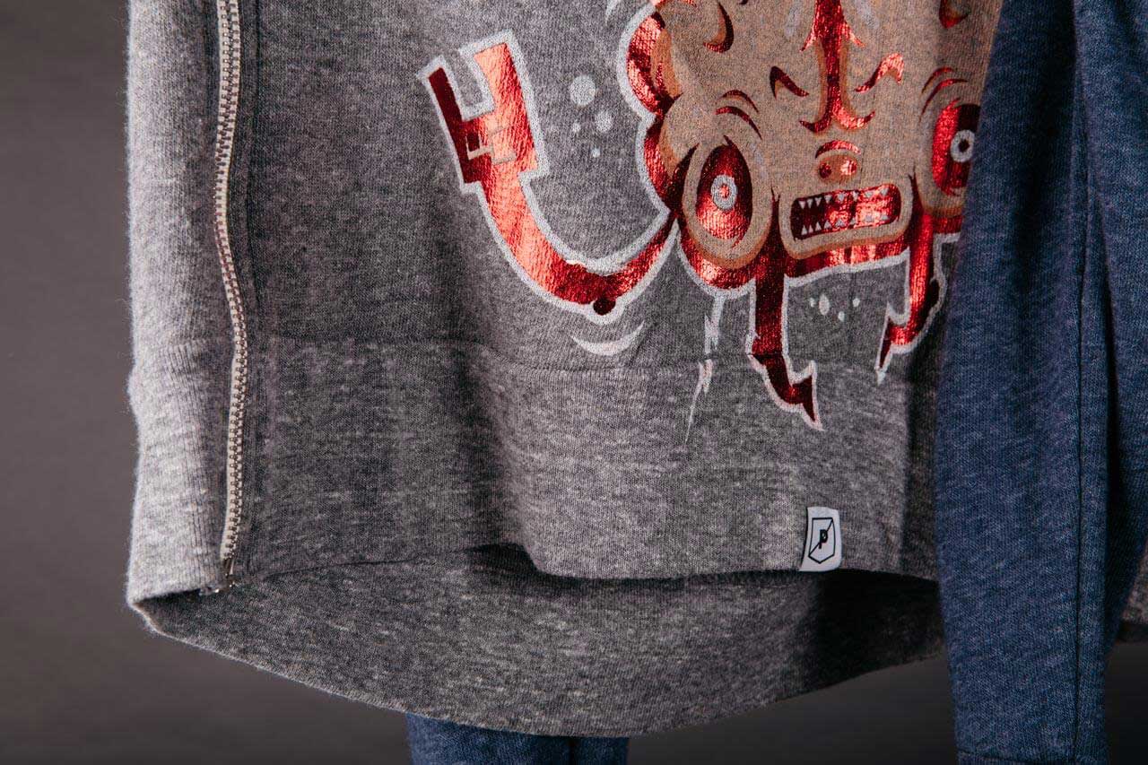 zip up jacket with red foil print on it