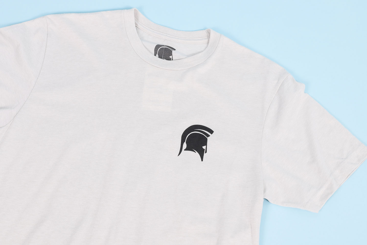 white t-shirt with small black spartan helmet logo on chest