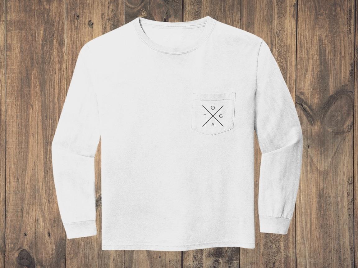 White sweatshirt with black X logo on front pocket against a wood background