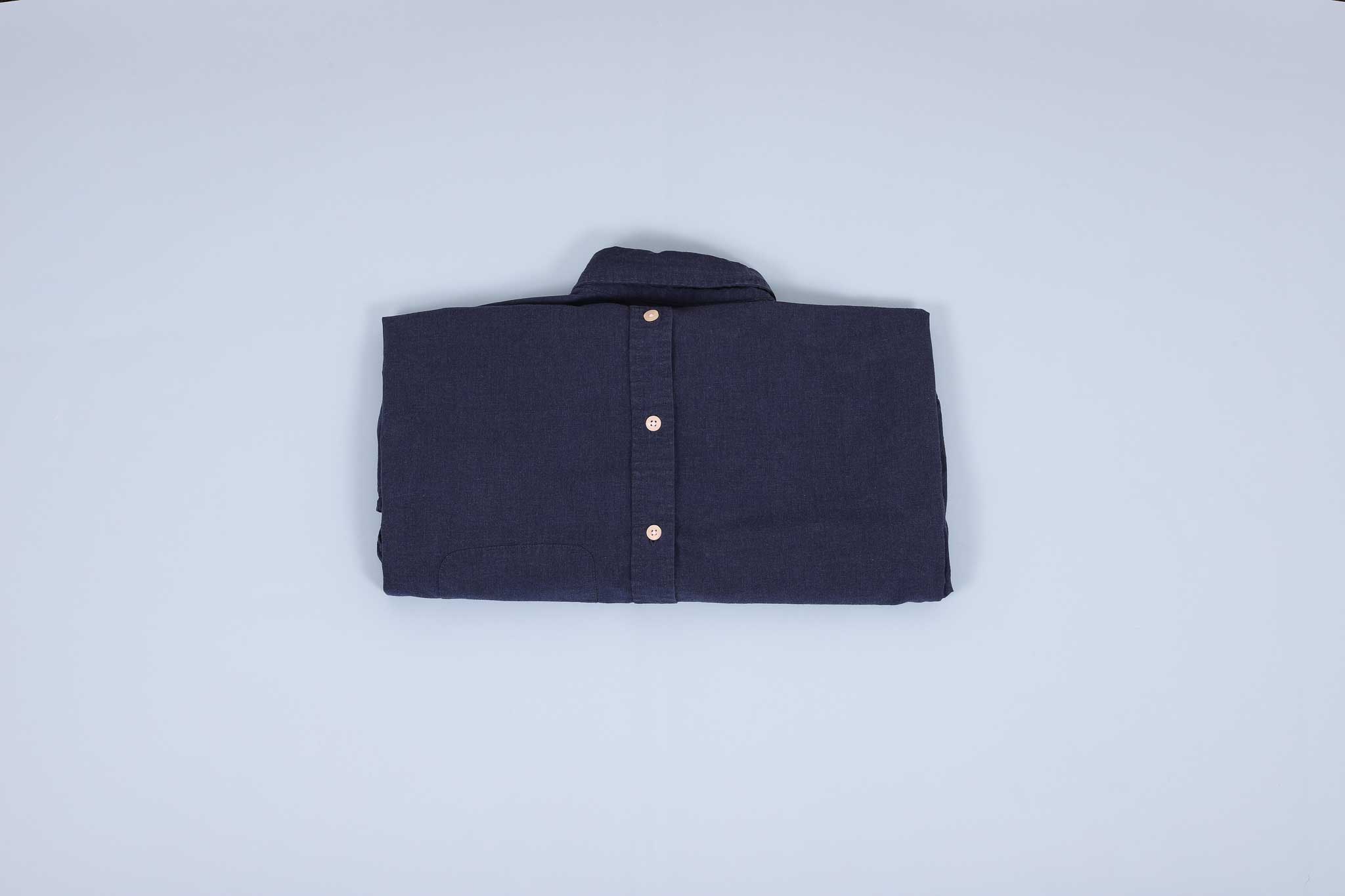 Navy dress shirt folded into thirds facing down